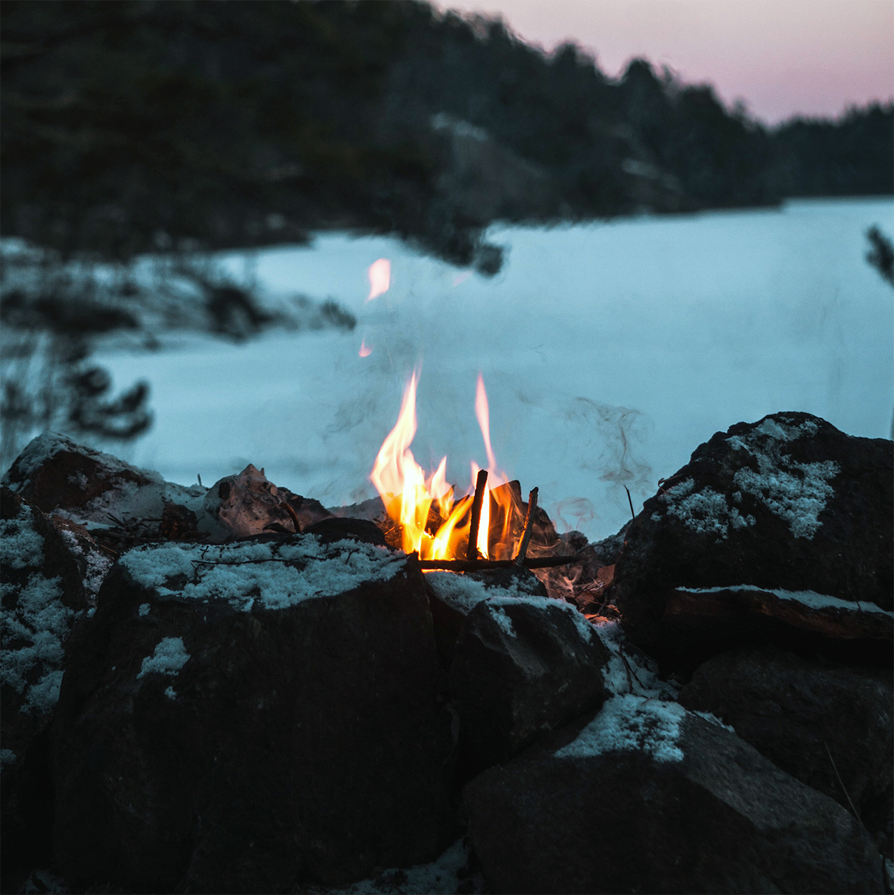 A small fire on the shore of a lake