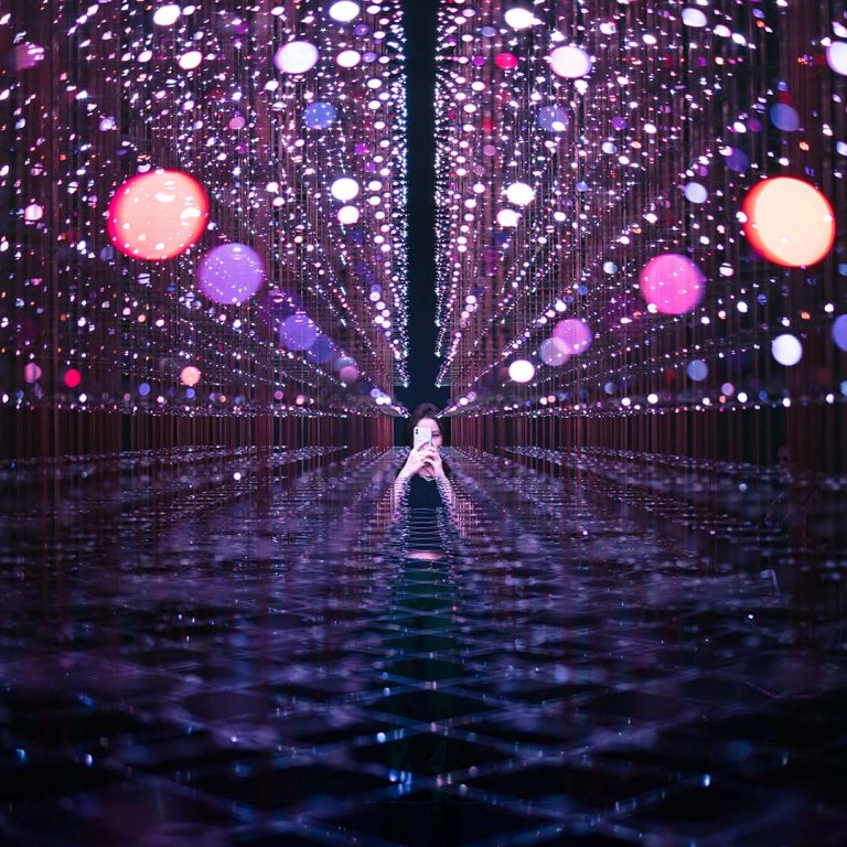 A virtual looking matrix of purples with a woman visible in the middle